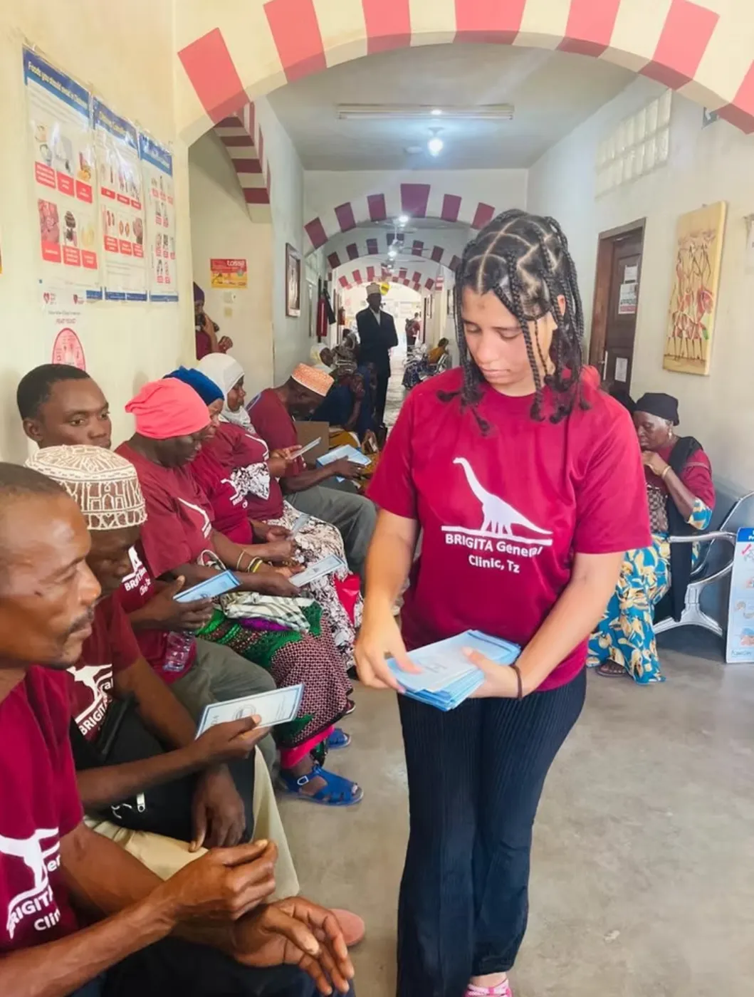 A team member handing out health leaflets in the Brigita waiting area